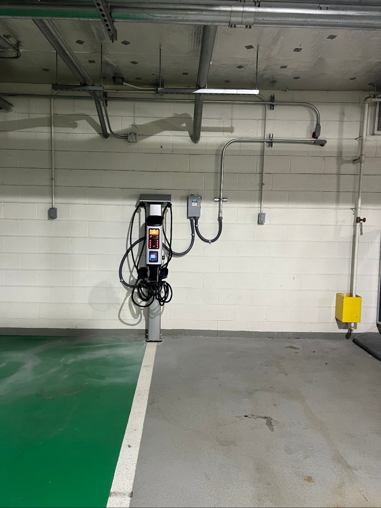 EV charging station and conduit in a parking garage in Washington, DC — Schmidt's Electrical